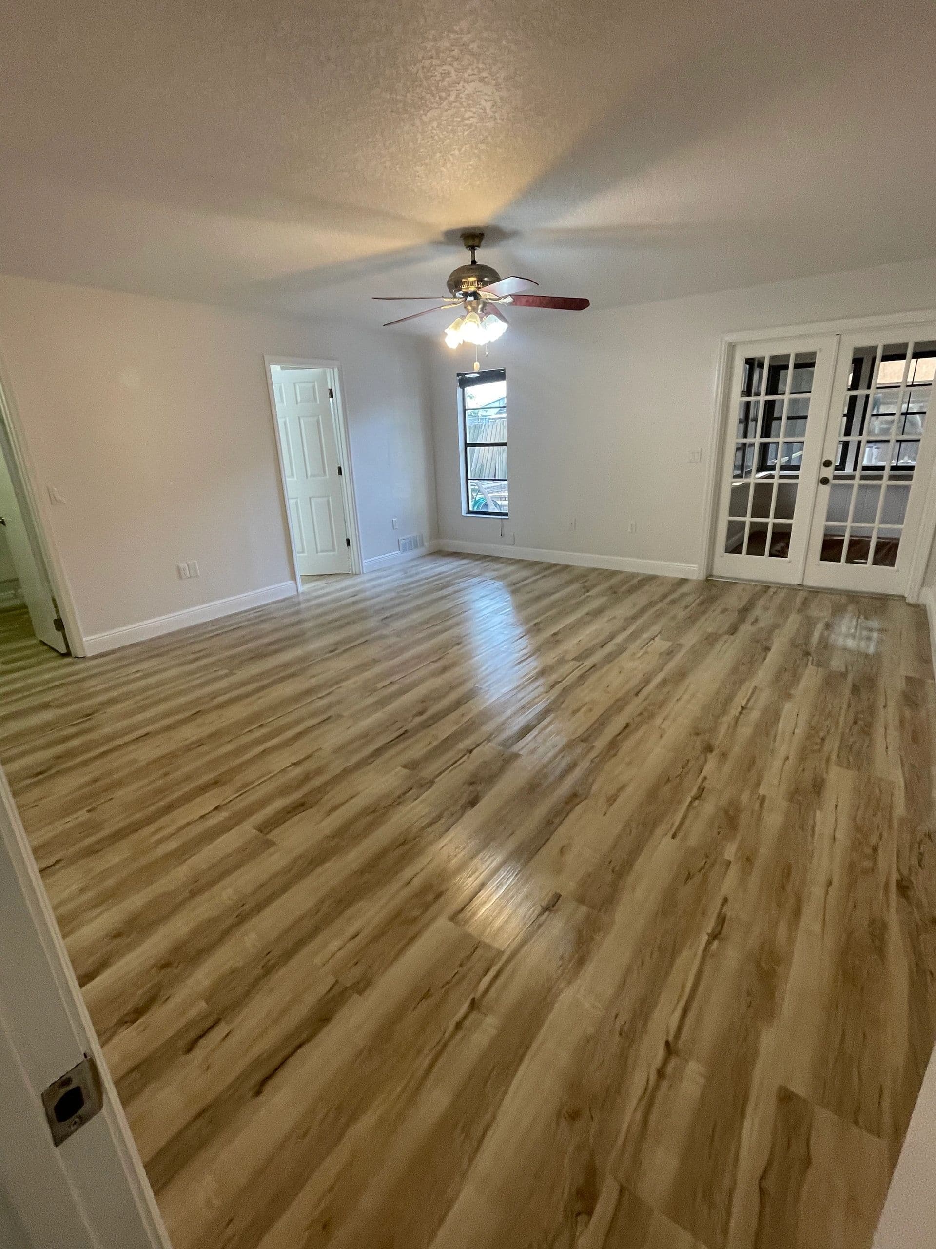 Finished wood-look plank flooring in an empty living room