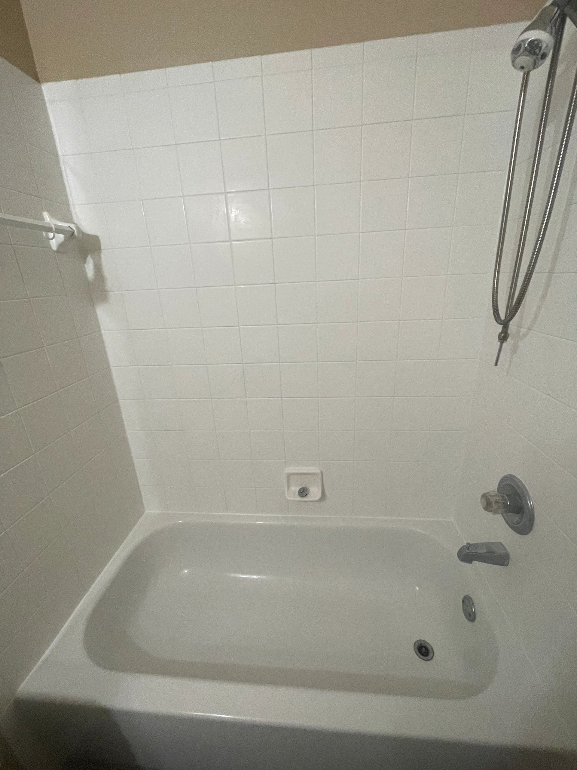 Clean white tile shower and tub surround after restoration